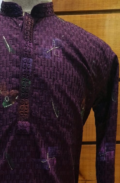 Purple embroidered garment on a wooden background