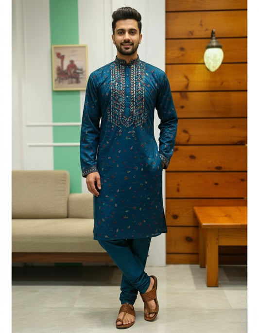 Man wearing a blue embroidered kurta in a living room setting