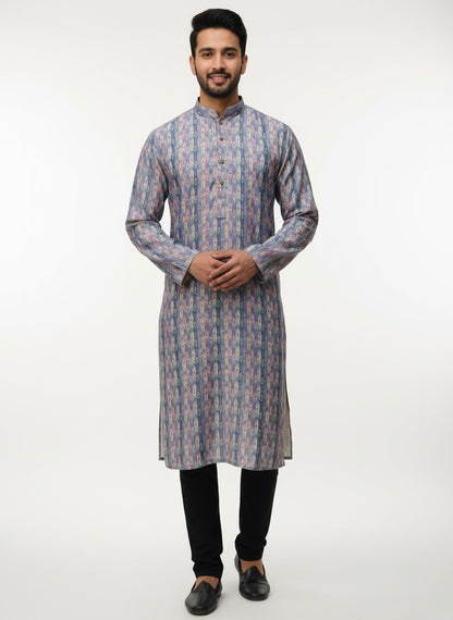 Man wearing a patterned kurta with black pants on a white background