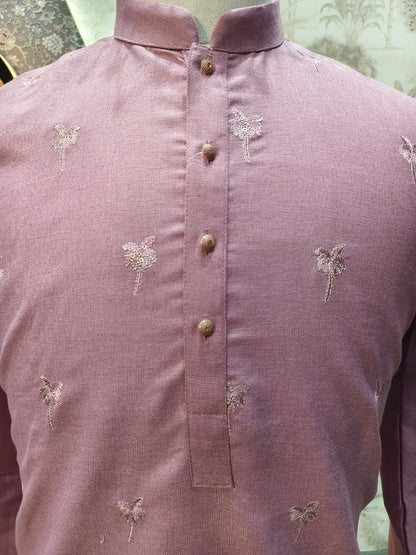Purple shirt with floral embroidery on a mannequin against a light green background