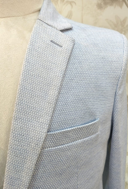 Light blue textured blazer on a mannequin with a neutral background