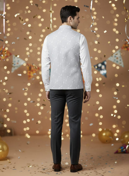 Man wearing a light-colored shirt and dark pants against a festive background with lights and decorations.